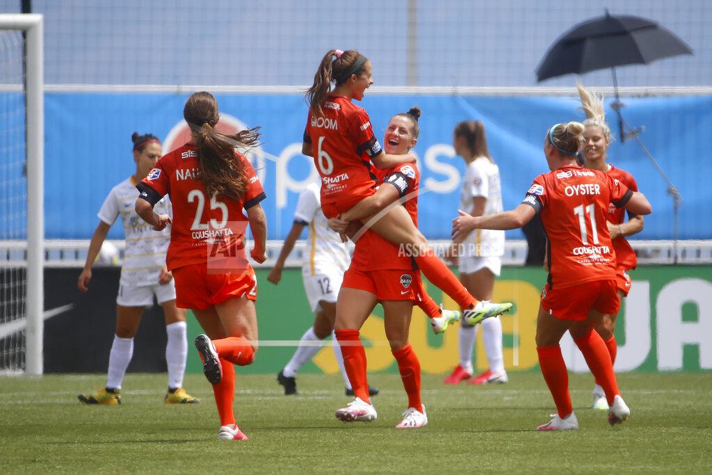 Rick Bowmer Houston Dash's Shea Groom (6) jumps in the arms of teammate Haley Hanson after scoring against the Utah Royals FC during the second half of an NWSL Challenge Cup soccer match at Zions Bank Stadium Tuesday, June 30, 2020, in Herriman, Utah. (AP Photo/Rick Bowmer)