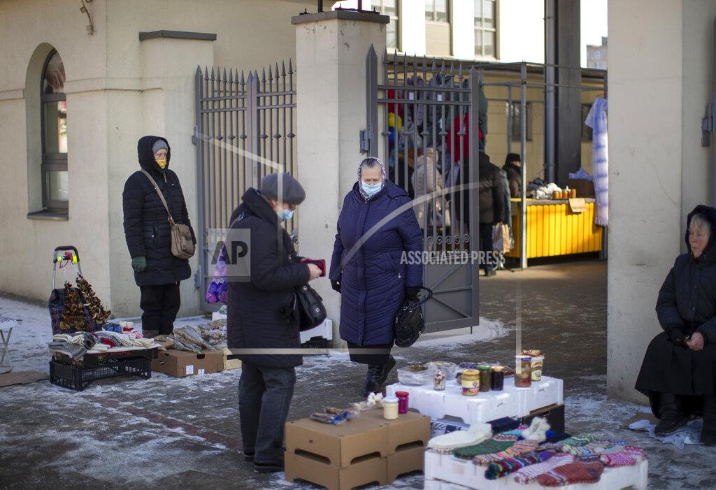 Mindaugas Kulbis Women wearing face masks to protect against coronavirus shop at the Kalvarijos market in Vilnius, Lithuania, Tuesday, March 9, 2021. The quarantine restrictions have contributed to slowing the spread of the coronavirus (COVID-19) in Lithuania, but morbidity rates are still high. (AP Photo/Mindaugas Kulbis)