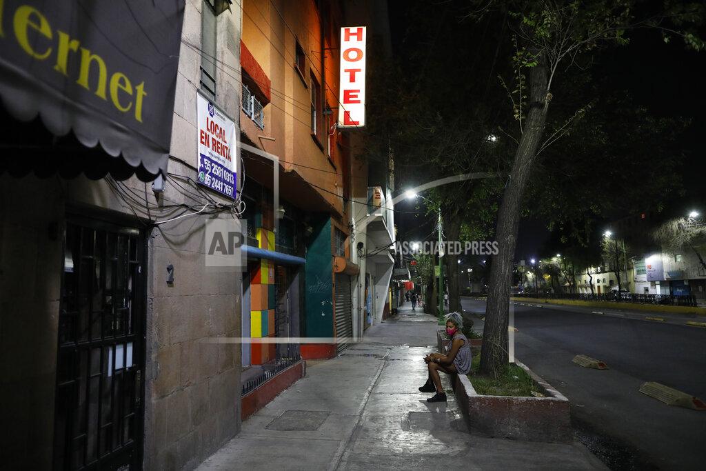 Rebecca Blackwell Homeless sex worker Angora, 26, waits outside a hotel as she tries to earn money after having her bag stolen by a man pretending to be a client, in Mexico City, Thursday, March 25, 2021. Rules of the partial lockdown due to the coronavirus pandemic forced many hotels to close, and others raised the prices they charge sex workers. That left some earning only three or four dollars from each client. (AP Photo/Rebecca Blackwell)