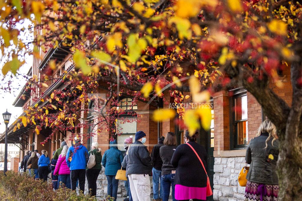 Kaytie Boomer Voters stand in line outside of Pere Marquette Depot to cast their ballots in Bay City, Mich., during Election Day on Tuesday, Nov. 3, 2020. (Kaytie Boomer/The Bay City Times via AP)