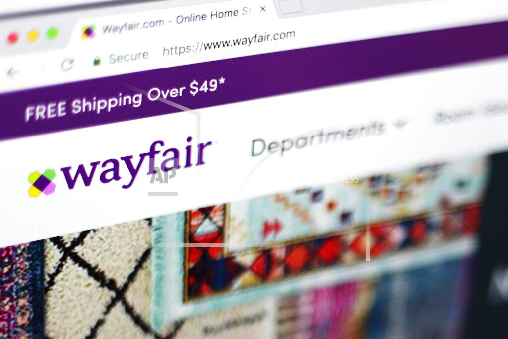 Jenny Kane FILE - This April 17, 2018 file photo shows the Wayfair website on a computer in New York. On Friday, July 17, 2020, The Associated Press reported on stories circulating online incorrectly asserting Niraj Shah, chief executive officer of the furniture company Wayfair, has resigned amid child sex trafficking allegations against the company. Shah has not stepped down, according to a Wayfair spokesperson, and claims the company is involved in child trafficking are part of an unfounded conspiracy theory. Other bogus claims spreading online include a parody Wayfair advertisement that’s been mistaken as real, and a photo of longtime Jeffrey Epstein associate Ghislaine Maxwell with a luxury watch businessman who’s been falsely identified as a Wayfair employee. (AP Photo/Jenny Kane, File)