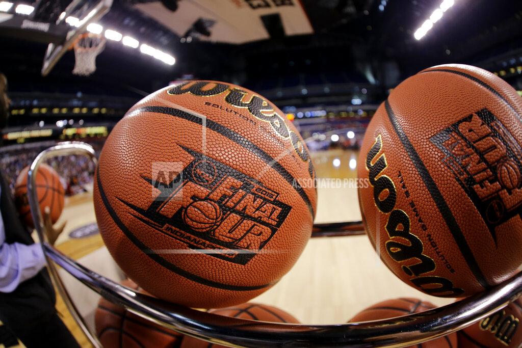 David J. Phillip FILE - In this April 3, 2015, file photo, basketballs sit in a rack during Michigan State practice at the Final Four of the NCAA college basketball tournament in Indianapolis. NCAA President Mark Emmert says NCAA Division I basketball tournament games will be played without fans in the arenas because of concerns about the spread of coronavirus. (AP Photo/David J. Phillip, File)