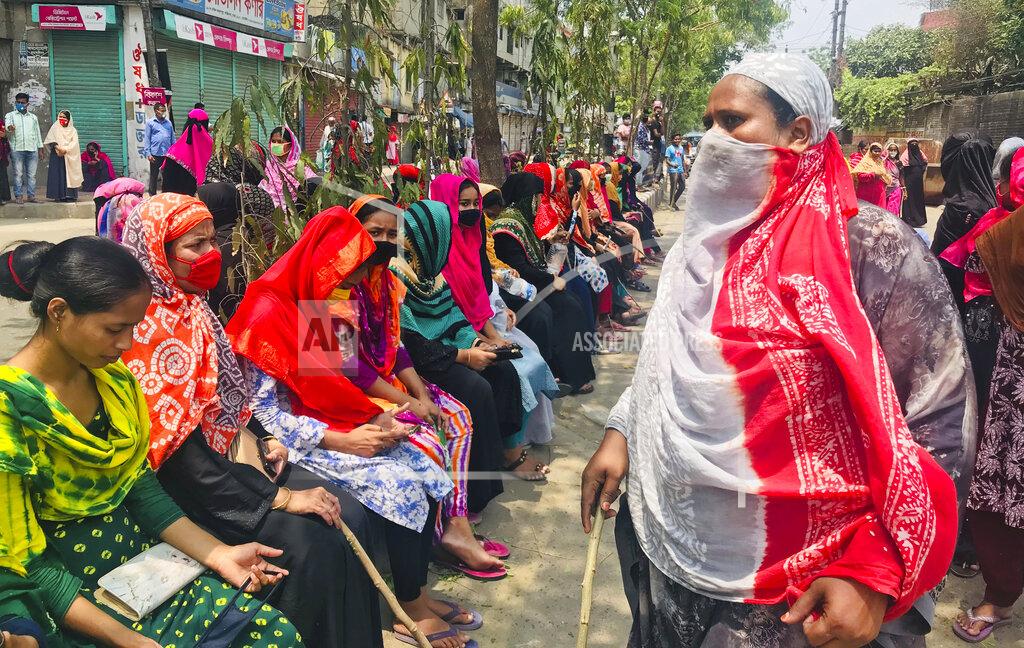 Al-Emrun Garjon Bangladeshi garment workers block a road demanding their unpaid wages during a protest in Dhaka, Bangladesh, Thursday, April 16, 2020. Hundreds of Bangladeshi workers who produce garments for global brands protested in Dhaka and blocked a highway outside the capital on Thursday to demand unpaid wages during a nationwide lockdown that has forced most factories to suspend operations. (AP Photo/Al-emrun Garjon)