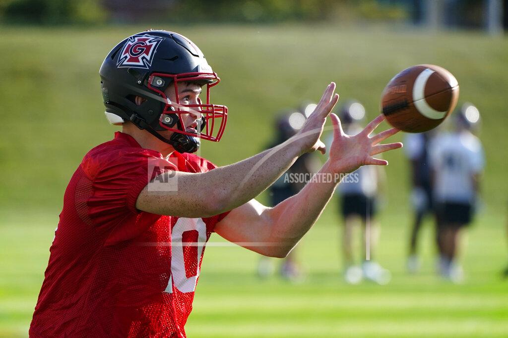 Grinnell College running back Danny Carter catches a pass during an NCAA college football practice, Friday, Oct. 8, 2021, in Grinnell, Iowa. Football is back at Division III Grinnell College, and with a new coach, lots of new players and a new look, the program is on its way to thriving rather than just surviving as it has in the past. (AP Photo/Charlie Neibergall)