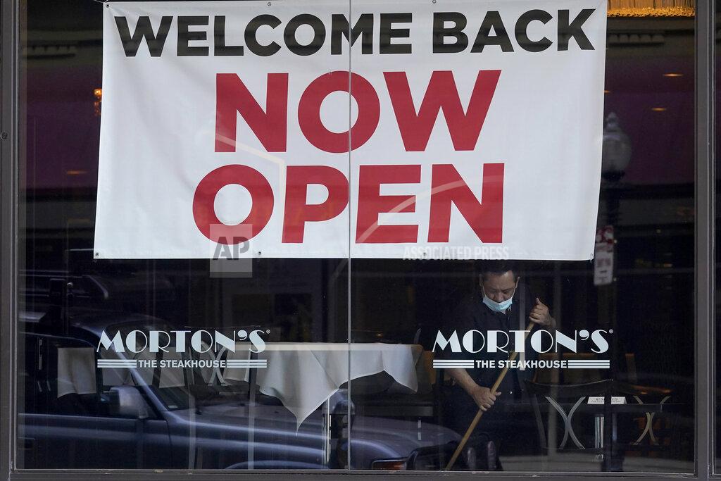 Jeff Chiu FILE - In this March 4, 2021, file photo, a sign reading "Welcome Back Now Open" is posted on the window of a Morton's Steakhouse restaurant as a man works inside in San Francisco. The Institute for Supply Management, an association of purchasing managers, reported Monday, April 5 that the U.S. services sector, which employs most Americans, recorded record growth in March as orders, hiring and prices all surged. (AP Photo/Jeff Chiu, File)