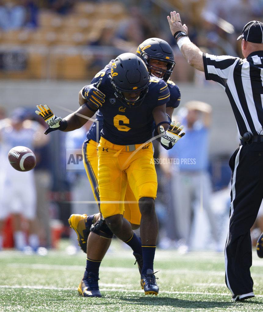 D. Ross Cameron FILE - In this Sept. 1, 2018, file photo, California's Jaylinn Hawkins (6) and Luc Bequette (93) celebrate Hawkins' interception of a pass by North Carolina quarterback Nathan Elliott during the second half of an NCAA college football game, in Berkeley, Calif. Both California and BYU are traveling a similar road in search of a turnaround this season. The two teams come into their game Saturday in Provo riding a wave of renewed confidence after impressive season-opening wins. (AP Photo/D. Ross Cameron, File)