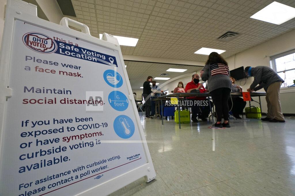 Tony Dejak A social distancing sign rests on the floor at the Middlefield Community Senior Center as voters pick up their ballots on Election Day in Middlefield, Ohio, Tuesday, Nov. 3, 2020. (AP Photo/Tony Dejak)