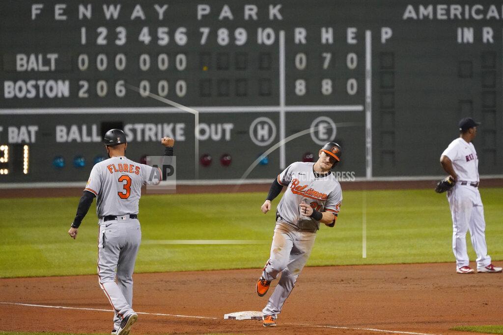 Charles Krupa Baltimore Orioles' Austin Hays, center, rounds the bases after hitting a solo home run off Boston Red Sox relief pitcher Mike Kickham during the seventh inning of a baseball game in Boston, Wednesday, Sept. 23, 2020, at Fenway Park. At left is Orioles third base coach Jose Flores. (AP Photo/Charles Krupa)