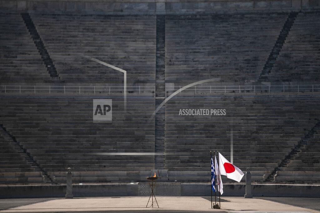 Yorgos Karahalis The Japanese flag flies next to an altar with the Olympic Flame of the Tokyo 2020 Olympic Games, inside the Panathenian stadium, in Athens, Sunday, March 15, 2020. The Panathenian Stadium will be closed to the spectators on Thursday, March 19 during the handover ceremony of the Olympic flame for the Tokyo 2020 Olympic Games as a precaution against the spread of the coronavirus. The vast majority of people recover from the new coronavirus. According to the World Health Organization, most people recover in about two to six weeks, depending on the severity of the illness. (AP Photo/Yorgos Karahalis)