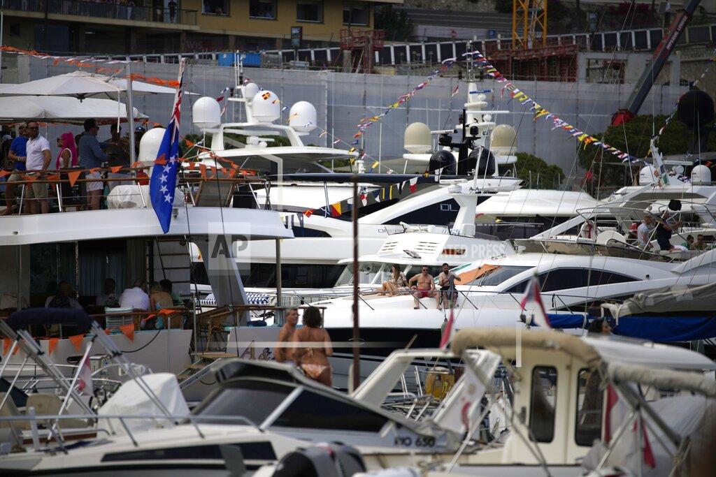 Daniel Cole People relax on yachts during qualifying session at the Monaco racetrack, in Monaco, Saturday, May 28, 2022. The Formula one race will be held on Sunday. (AP Photo/Daniel Cole)