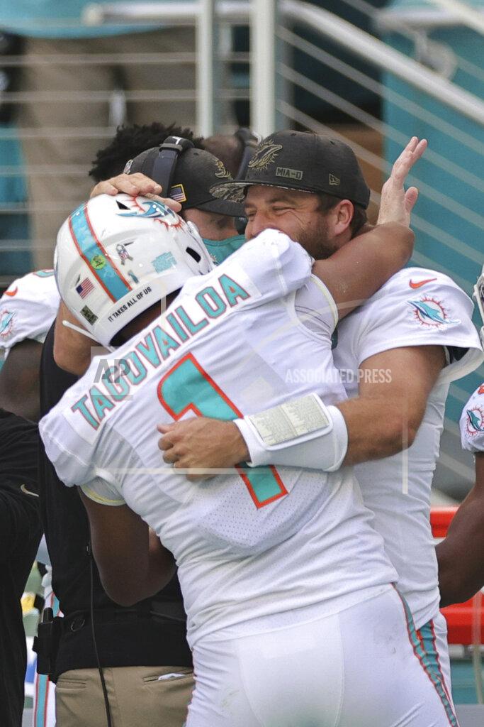 Margaret Bowles Miami Dolphins quarterback Tua Tagovailoa (1) and quarterback Ryan Fitzpatrick (14) embrace after Tagovailoa throws his first touchdown pass during an NFL game against the Los Angeles Rams, Sunday, Nov. 1, 2020 in Miami Gardens, Fla. The Dolphins defeated the Rams 28-17. (Margaret Bowles via AP)