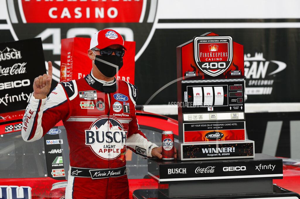 Paul Sancya Kevin Harvick celebrates after winning a NASCAR Cup Series auto race at Michigan International Speedway in Brooklyn, Mich., Saturday, Aug. 8, 2020. (AP Photo/Paul Sancya)