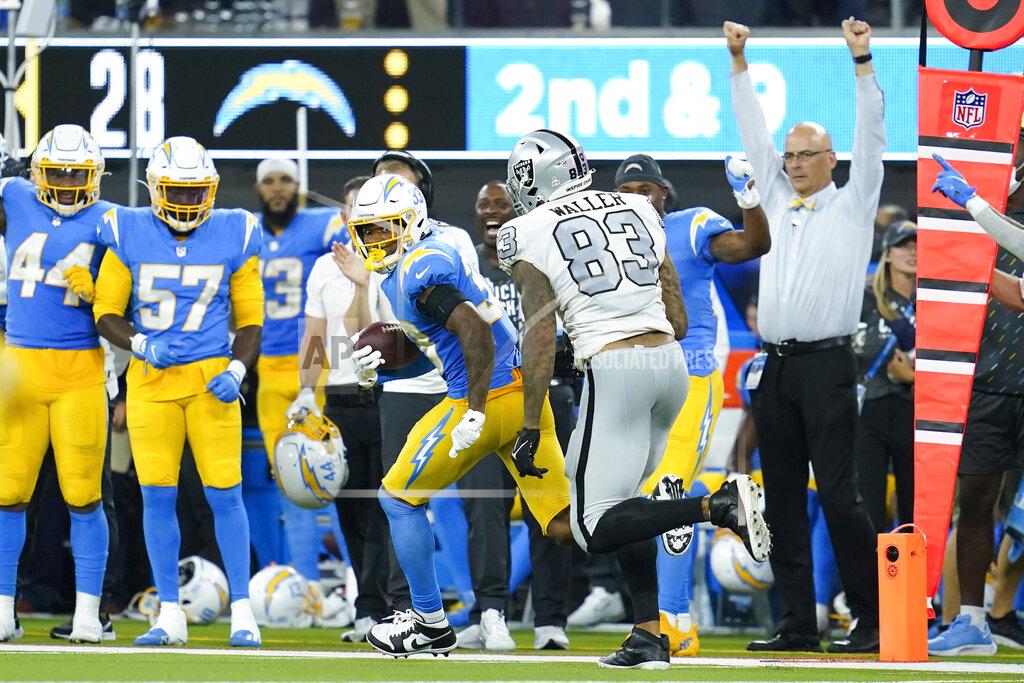 Ashley Landis Los Angeles Chargers free safety Derwin James runs with the ball after an interception as Las Vegas Raiders tight end Darren Waller defends during the second half of an NFL football game Monday, Oct. 4, 2021, in Inglewood, Calif. (AP Photo/Ashley Landis)