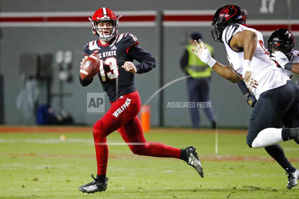 Karl B Deblaker North Carolina State's Devin Leary (13) scrambles away from Louisville's Jared Goldwire (90) during the first half of an NCAA college football game in Raleigh, N.C., Saturday, Nov. 16, 2019. (AP Photo/Karl B DeBlaker)