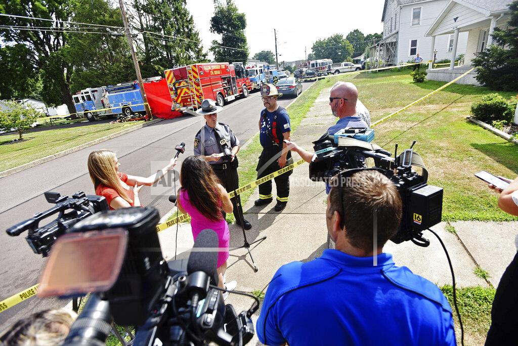 Sean Mckeag Lt. Derek Felsman, of the Pennsylvania State Police and Chief Harry Knorr, of the Nescopeck Volunteer Fire Co., hold a press conference with details involving a fatal fire on 1st. St. in Nescopeck, Pa., Friday, Aug. 5, 2022. Fire tore quickly through a house in the wee hours of Friday, killing multiple people and horrifying a volunteer firefighter who arrived to battle the blaze only to discover that the victims were his family, authorities said. (Sean McKeag/The Citizens' Voice via AP)
