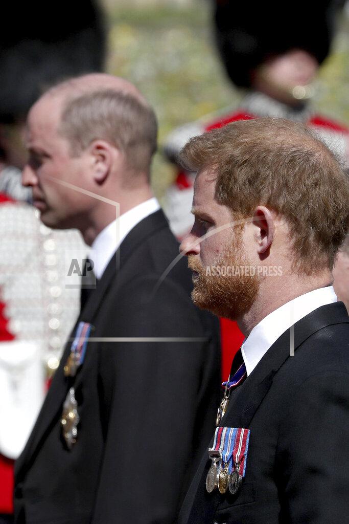 Gareth Fuller Britain's Prince William, left, and Prince Harry follow the coffin as it slowly makes its way in a ceremonial procession during the funeral of Britain's Prince Philip inside Windsor Castle in Windsor, England, Saturday, April 17, 2021. (Gareth Fuller/Pool via AP)