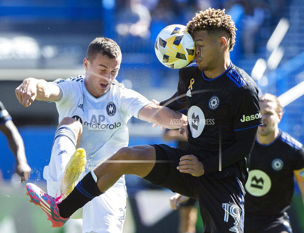 Graham Hughes CF Montreal's Zorhan Bassong, right, challenges Chicago Fire FC's Boris Sekulic during first half MLS soccer action in Montreal, Sunday, Sept. 19, 2021. (Graham Hughes/The Canadian Press via AP)