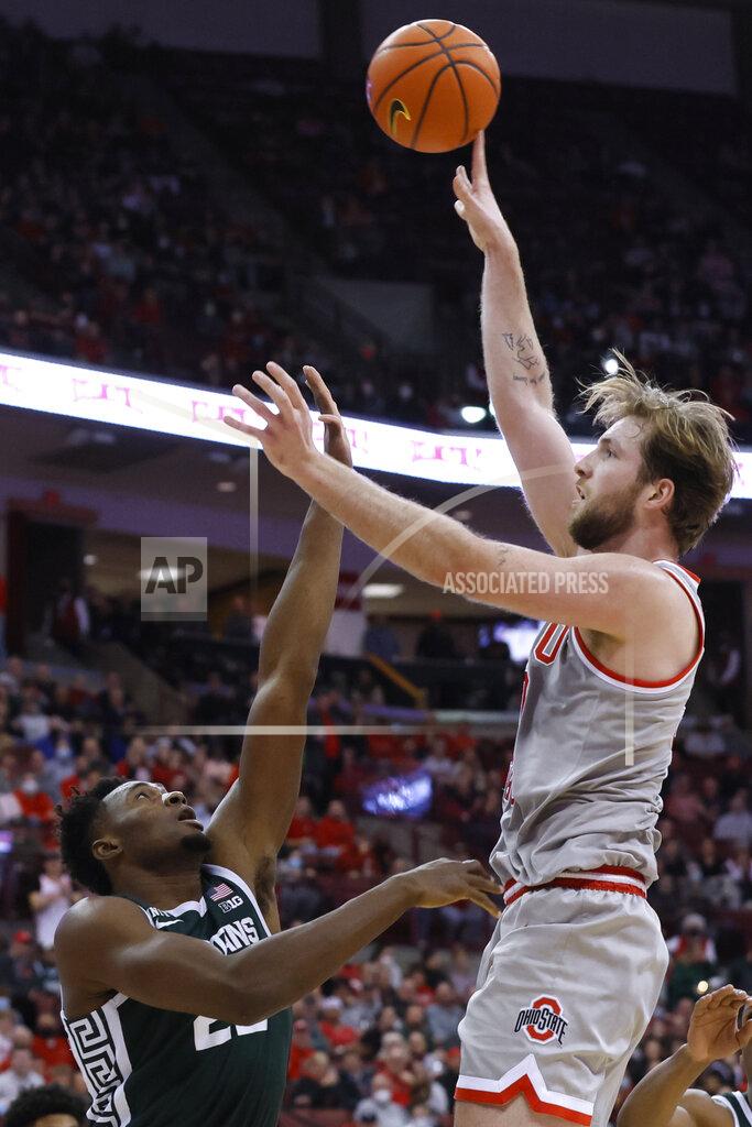 Jay Laprete Ohio State's Joey Brunk, right, shoots over Michigan State's Mady Sissoko during the second half of an NCAA college basketball game Thursday, March 3, 2022, in Columbus, Ohio. (AP Photo/Jay LaPrete)