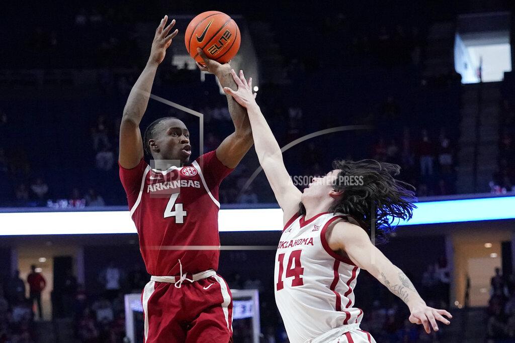 Sue Ogrocki Arkansas guard Davonte Davis (4) shoots over Oklahoma guard Bijan Cortes (14) in the second half of an NCAA college basketball game Saturday, Dec. 11, 2021, in Tulsa, Okla. (AP Photo/Sue Ogrocki)