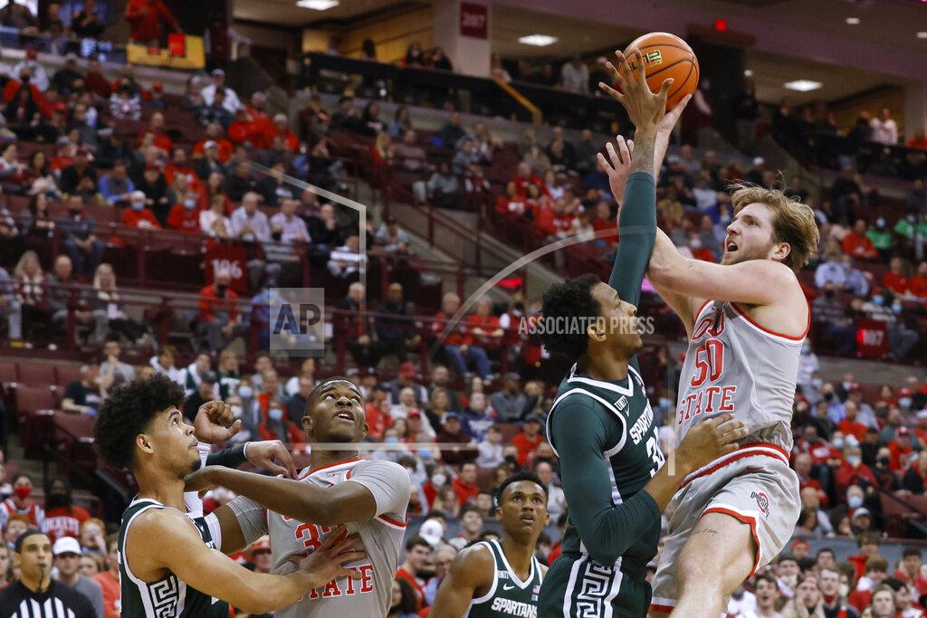 Jay Laprete Ohio State's Joey Brunk, right, shoots over Michigan State's Marcus Bingham during the second half of an NCAA college basketball game Thursday, March 3, 2022, in Columbus, Ohio. (AP Photo/Jay LaPrete)