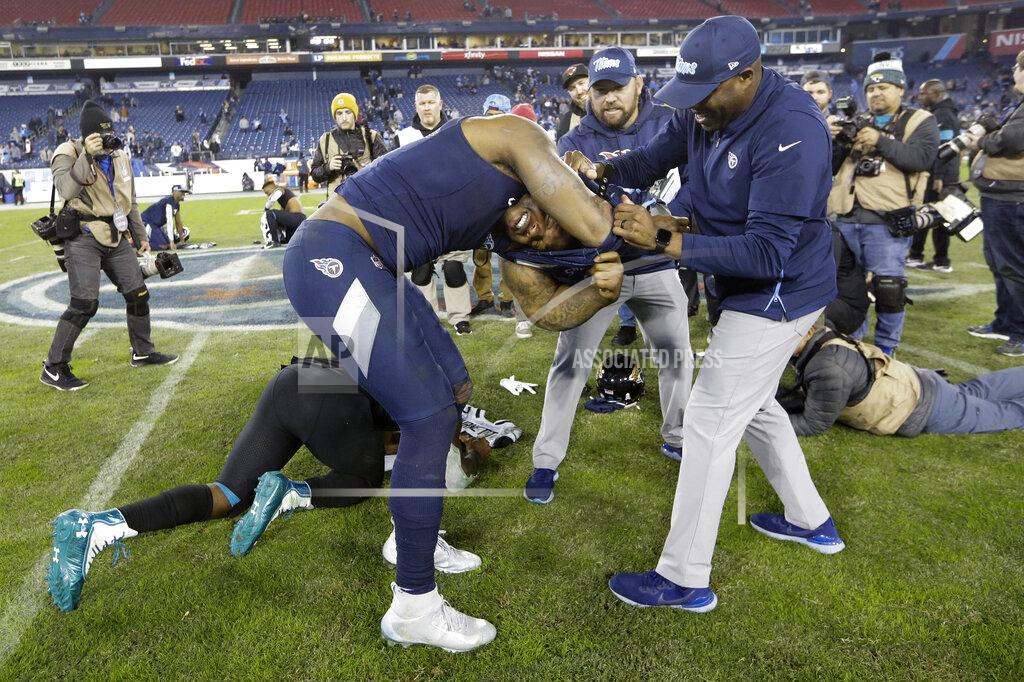 James Kenney Tennessee Titans running back Derrick Henry gets help taking his jersey and shoulder pads off so he can trade jerseys with Jacksonville Jaguars running back Leonard Fournette after an NFL football game Sunday, Nov. 24, 2019, in Nashville, Tenn. The Titans won 42-20. (AP Photo/James Kenney)