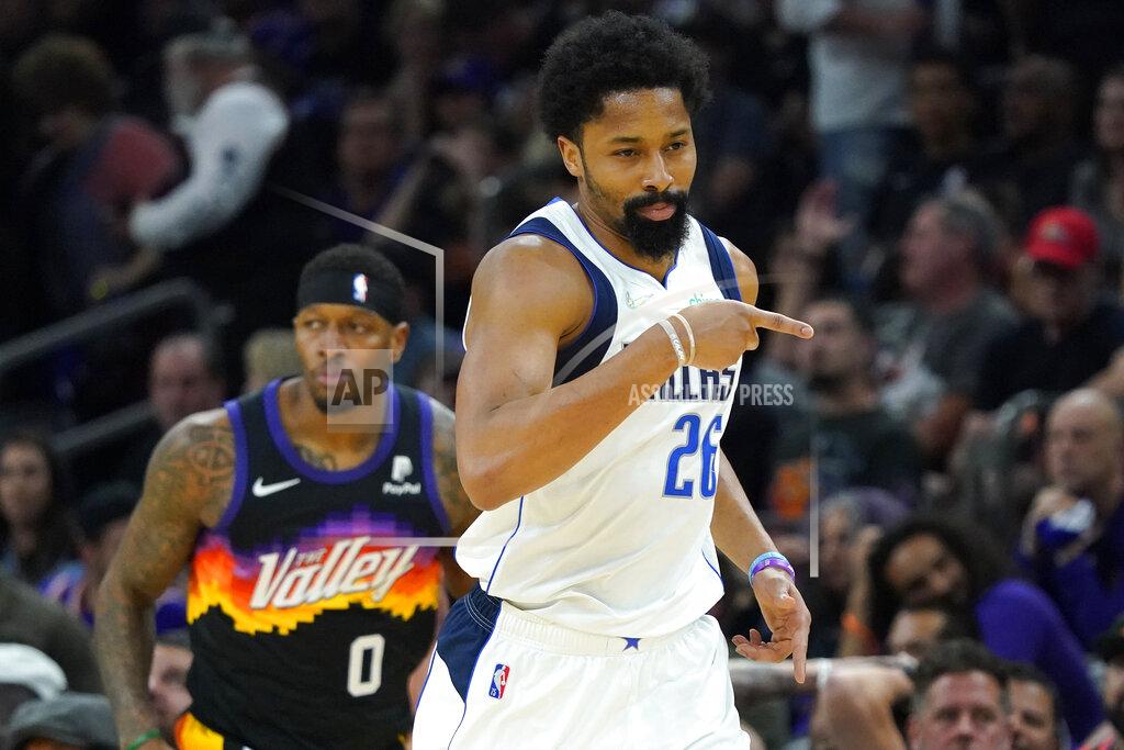 Matt York Dallas Mavericks guard Spencer Dinwiddie (26) points after a three pointer against the Phoenix Suns during the first half of Game 7 of an NBA basketball Western Conference playoff semifinal, Sunday, May 15, 2022, in Phoenix. The Mavericks defeated the Suns 123-90. (AP Photo/Matt York)