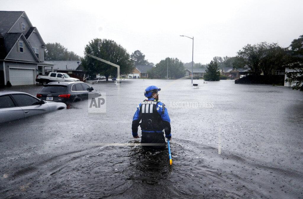 David Goldman FILE - In this Sunday, Sept. 16, 2018 file photo, a member of the North Carolina Task Force urban search and rescue team wades through a flooded neighborhood looking for residents who stayed behind as Florence continues to dump heavy rain in Fayetteville, N.C. According to data released by the National Oceanic and Atmospheric Administration on Tuesday, May 4, 2021, the new United States normal is not just hotter, but wetter in the eastern and central parts of the nation and considerably drier in the West than just a decade earlier. (AP Photo/David Goldman)