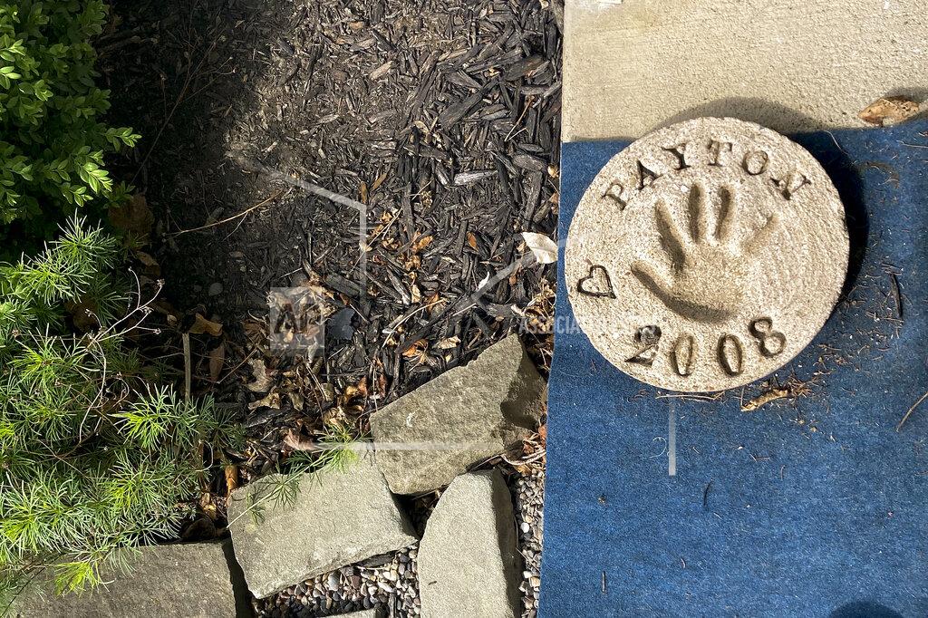 Michael Hill A plaster imprint of Payton Gendron's hand from 2008 sits on the front porch of his home, Monday, May 16, 2022, in Conklin, N.Y. Authorities say the white 18-year-old who killed 10 people at a Buffalo supermarket during a rampage that targeted Black people had previously made a threat at his high school. But they say Payton Gendron was never charged with a crime and had no further contact with law enforcement after his release from a hospital. (AP Photo/Michael Hill)