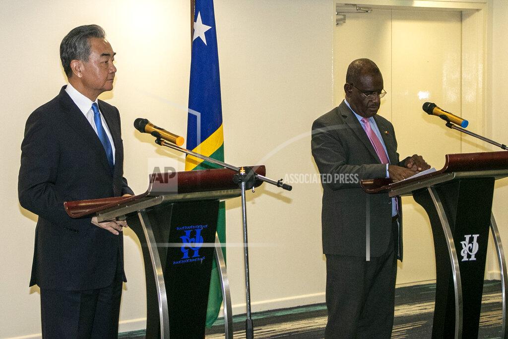 Uncredited China's Foreign Minister Wang Yi, left, and his counterpart from the Solomon Islands, Jeremiah Manele hold a joint news conference in Honiara, Solomon Islands, early Thursday, May 26, 2022. Wang and a 20-strong delegation have arrived in the Solomon Islands at the start of an eight-nation Pacific tour that comes amid growing concerns about Beijing's military and financial ambitions in the region. (AP Photo)