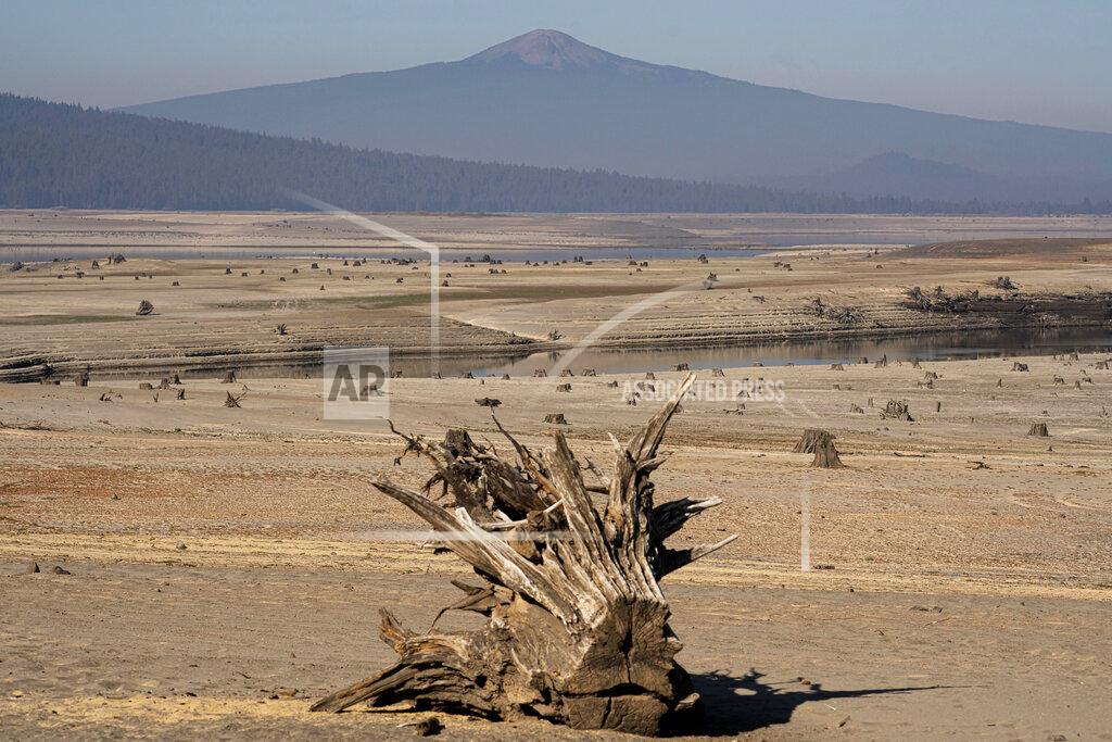 Nathan Howard The dry lake bed of the Wickiup Reservoir is exposed by drought conditions that left the reservoir at 1 percent capacity on Wednesday, Sept. 1, 2021, near La Pine, Ore. As catastrophic drought ravages the West, the irrigation districts with water claims dating back more than a century are first in line for scarce water while others just up the road with more recent claims have already run out. (AP Photo/Nathan Howard)