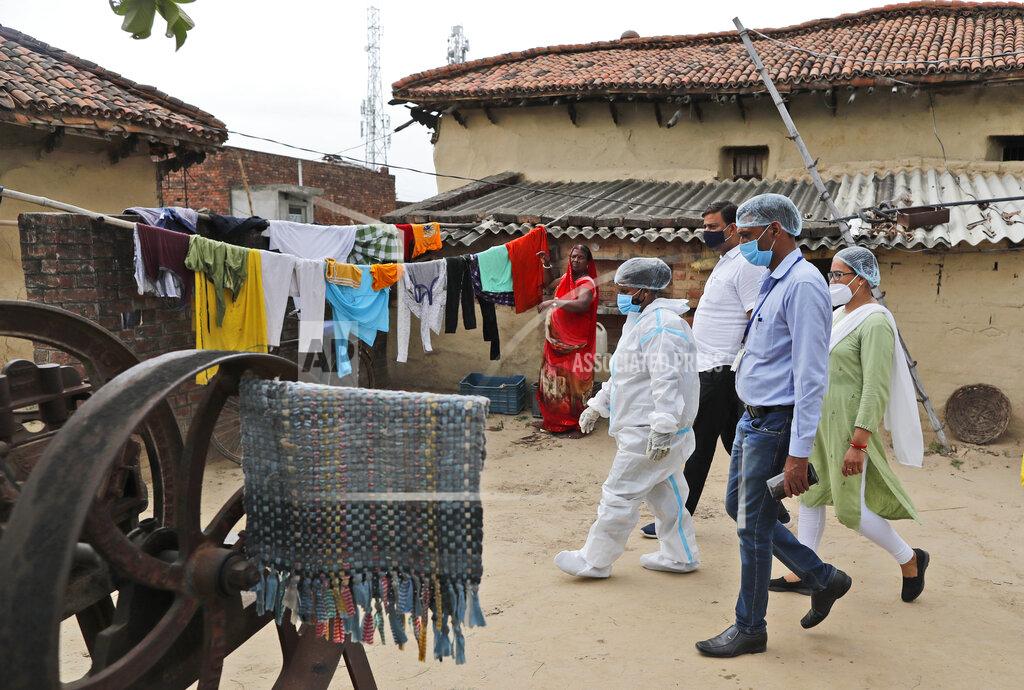 Rajesh Kumar Singh Health workers arrive to test villagers for COVID-19 and to persuade them get vaccinated at Sikanderpur village, Uttar Pradesh state, India, on June 9, 2021. India's vaccination efforts are being undermined by widespread hesitancy and fear of the jabs, fueled by misinformation and mistrust. That's especially true in rural India, where two-thirds of the country’s nearly 1.4 billion people live. (AP Photo/Rajesh Kumar Singh)