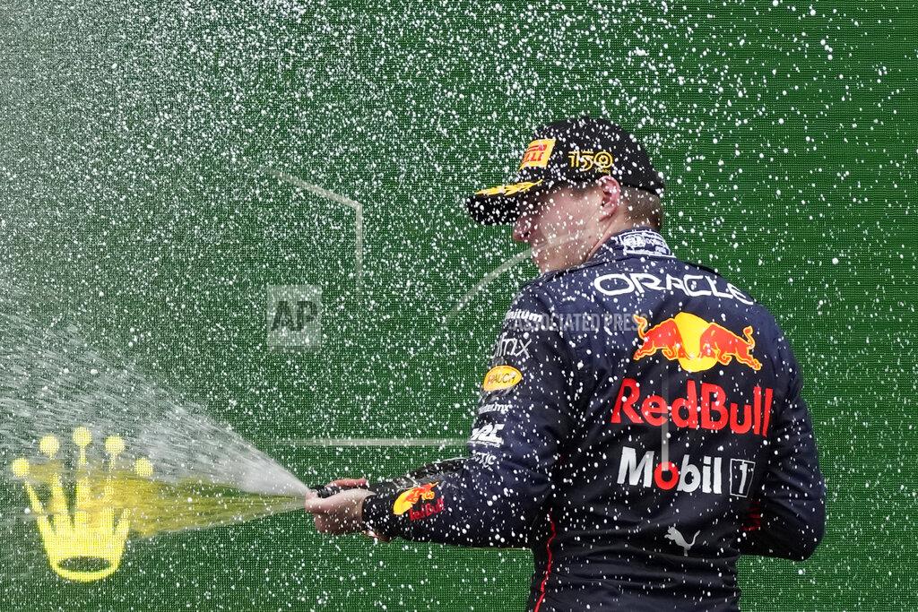 Luca Bruno Red Bull driver Max Verstappen, of the Netherlands, celebrates on the podium after winning the Emilia Romagna Formula One Grand Prix, at the Enzo and Dino Ferrari racetrack, in Imola, Italy, Sunday, April 24, 2022. (AP Photo/Luca Bruno)