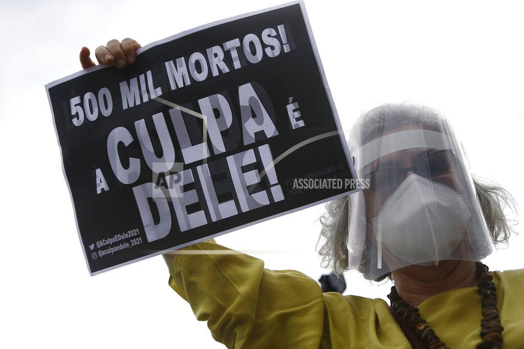 Bruna Prado A demonstrator holds a sign with a message that reads in Portuguese; "500K deaths! His fault!" during a demonstration against Brazilian President Jair Bolsonaro's handling of the coronavirus pandemic and economic policies protesters say harm the interests of the poor and working class, in Rio de Janeiro, Brazil, Saturday, June 19, 2021. Brazil is approaching an official COVID-19 death toll of 500,000 — second-highest in the world. (AP Photo/Bruna Prado)