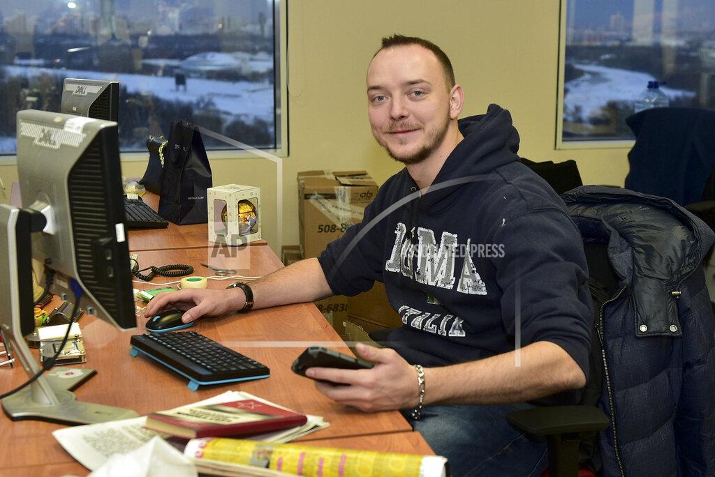 Peter Kassin ADDING RUSSIA OUT - In this photo taken on Sunday, Jan. 10, 2016, Ivan Safronov looks at a photographer in his working place in Kommersant Publishing House in Moscow, Russia. Safronov, an adviser to the director of Russia's state space corporation Roscosmos, has been detained on treason charges by the nation's top security agency. (Peter Kassin, Kommersant Photo via AP)