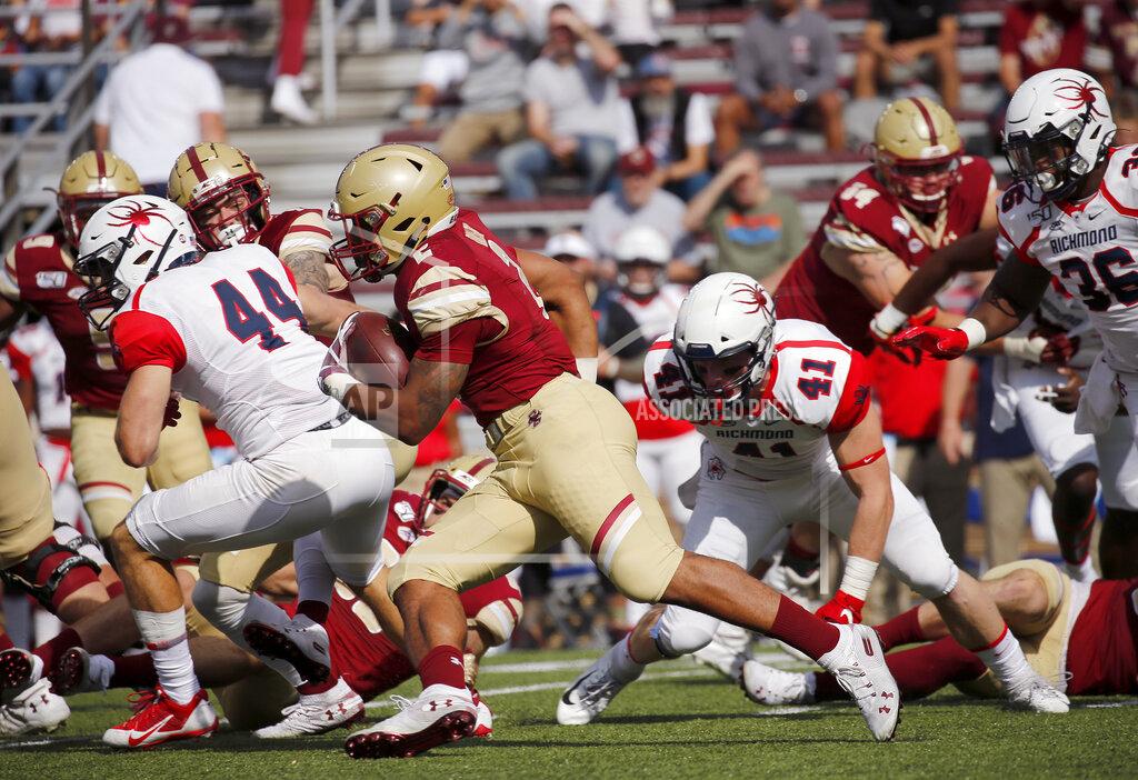 Mary Schwalm Boston College running back AJ Dillon (2) rushes past Richmond defenders during the first half of an NCAA college football game, Saturday, Sept. 7, 2019, in Boston. (AP Photo/Mary Schwalm)