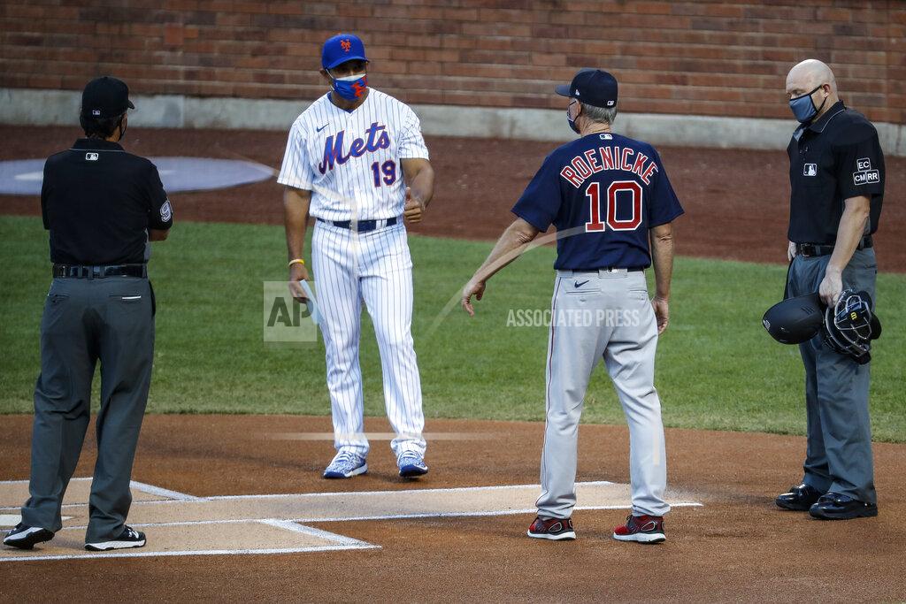 John Minchillo New York Mets manager Luis Rojas (19) and Boston Red Sox manager Ron Roenicke (10) maintain social distance during a meeting at home plate before a baseball game, Wednesday, July 29, 2020, in New York. (AP Photo/John Minchillo)