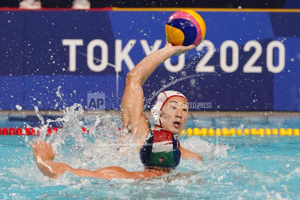 Mark Humphrey Japan's Toi Suzuki, top, protects the ball from Hungary's Daniel Angyal, bottom, during a preliminary round men's water polo match at the 2020 Summer Olympics, Tuesday, July 27, 2021, in Tokyo, Japan. (AP Photo/Mark Humphrey)