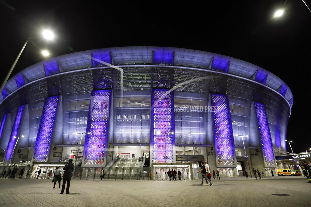 Laszlo Balogh FILE - In this file photo dated Thursday, Sept. 24, 2020, a few people walk outside the stadium before the UEFA Super Cup soccer match between Bayern Munich and Sevilla at the Puskas Arena in Budapest, Hungary. With coronavirus restrictions eased to allow fans back into stadiums, there at least will be some atmosphere at the tournament after months of games being played without any. Budapest wants all fans to come, while Saint Petersburg and Baku hope to use 50% of stadium capacity. (AP Photo/Laszlo Balogh, File)