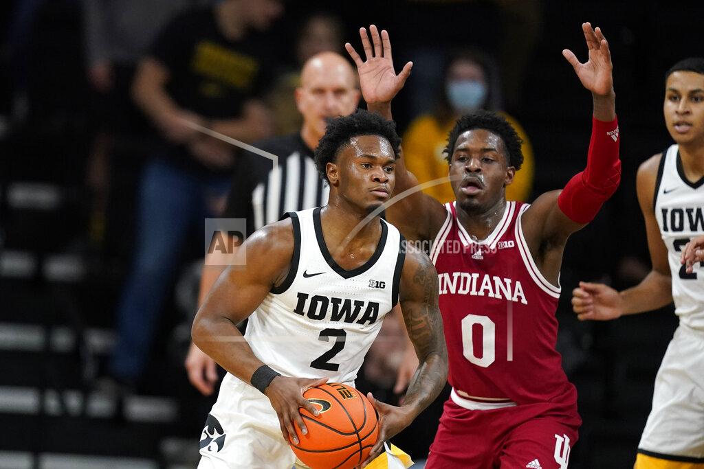 Charlie Neibergall Iowa guard Joe Toussaint (2) passes ahead of Indiana guard Xavier Johnson (0) during the first half of an NCAA college basketball game, Thursday, Jan. 13, 2022, in Iowa City, Iowa. (AP Photo/Charlie Neibergall)