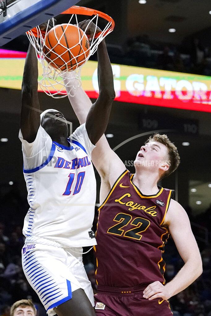 Nam Y. Huh DePaul forward Yor Anei, left, dunks against Loyola center Jacob Hutson during the second half of an NCAA college basketball game in Chicago, Saturday, Dec. 4, 2021. (AP Photo/Nam Y. Huh)