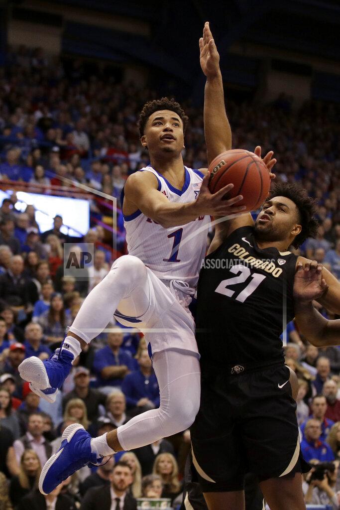 Charlie Riedel Kansas' Devon Dotson (1) shoots over Colorado's Evan Battey (21) during the first half of an NCAA college basketball game Saturday, Dec. 7, 2019, in Lawrence, Kan. (AP Photo/Charlie Riedel)