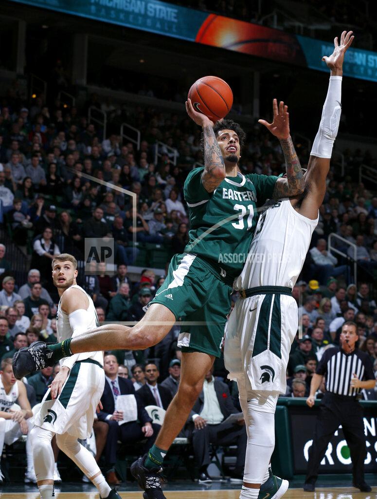 Eastern Michigan's Ty Groce, front left, goes to the basket against Michigan State's Xavier Tillman during the first half of an NCAA college basketball game, Saturday, Dec. 21, 2019, in East Lansing, Mich. (AP Photo/Al Goldis)