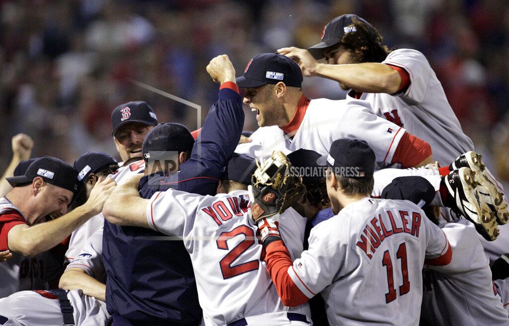 Al Behrman FILE - In this Oct. 27, 2004, file photo, Boston Red Sox players celebrate after defeating the St. Louis Cardinals in Game 4 to win the World Series in St. Louis. The Cardinals and the Red Sox would have had one of their rare regular-season series this week. They have met in four different World Series. They would have played a three-game series at Fenway Park this week if not for the coronavirus pandemic. (AP Photo/Al Behrman, File)
