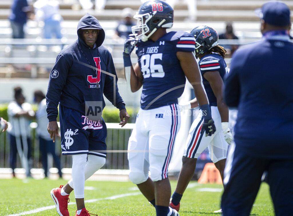 Eric Shelton Jackson State head football coach Deion Sanders, left, prepares for JSU's NCAA college football game against Alabama A&M, Saturday, April 10, 2021, at Veterans Memorial Stadium in Jackson, Miss. (Eric Shelton/The Clarion-Ledger via AP)