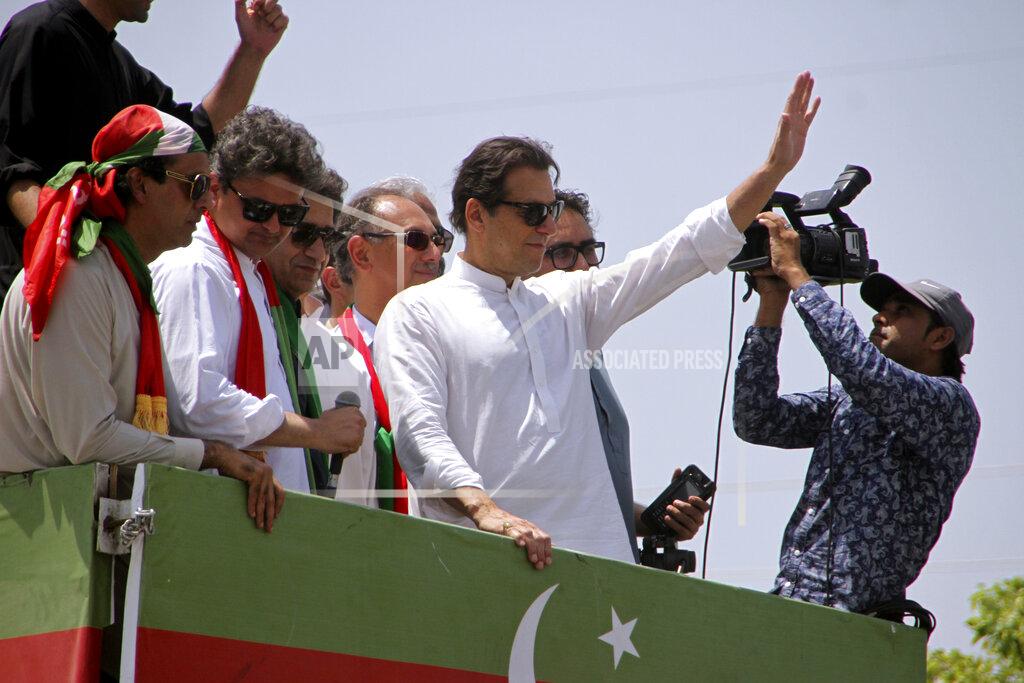 Mohammad Zubair Ousted Pakistani Prime Minister Imran Khan waves to supporters as he leads a march toward Islamabad, in Swabi, Pakistan, Wednesday, May 25, 2022. Pakistani police have fired tear gas and scuffled with stone-throwing supporters of Khan as they gathered for planned marches Wednesday toward central Islamabad. The defiant former premier had called followers to a rally outside Parliament to bring down the government and force early elections. (AP Photo/Mohammad Zubair)