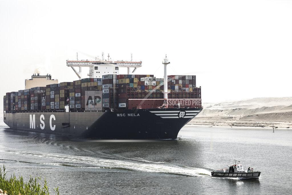 Mohamed Elshahed A container ship passes through Suez Canal, Egypt, Tuesday, April 6, 2021. The Suez Canal chief said that authorities are negotiating a financial settlement with the owners of a massive vessel that blocked the crucial waterway for nearly a week. (AP Photo/Mohamed Elshahed)
