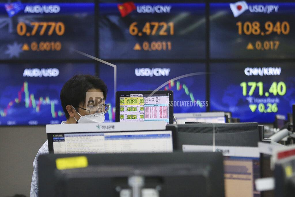 Ahn Young-Joon A currency trader watches monitors at the foreign exchange dealing room of the KEB Hana Bank headquarters in Seoul, South Korea, Friday, April 30, 2021. Asian shares were mostly lower Friday amid uncertainty about the prospects for a gradual global economic recovery from the coronavirus pandemic. (AP Photo/Ahn Young-joon)