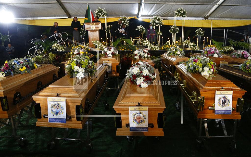 Uncredited A view of the coffins during a funeral service held in Scenery Park, East London, South Africa, Wednesday, July 6, 2022. More than a thousand grieving family and community members are attending the funeral in South Africa's East London for 21 teenagers who died in a mysterious tragedy at a nightclub nearly two weeks ago. South African President Cyril Ramaphosa is due to give the eulogy for the young who died. (AP Photo)