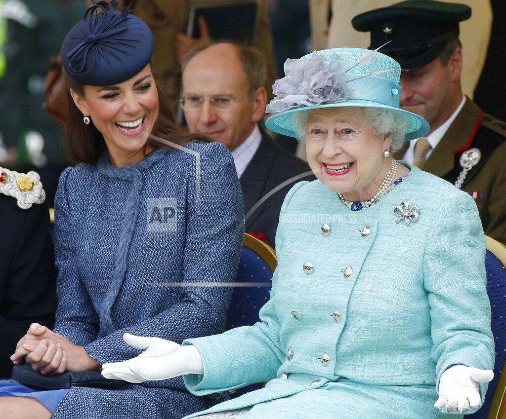 Phil Noble FILE - Britain's Kate, Duchess of Cambridge, left, laughs as Britain's Queen Elizabeth II gestures while they watch a children's sports event during a visit to Vernon Park in Nottingham, central England, on June 13, 2012. (AP Photo/Phil Noble, Pool, File)
