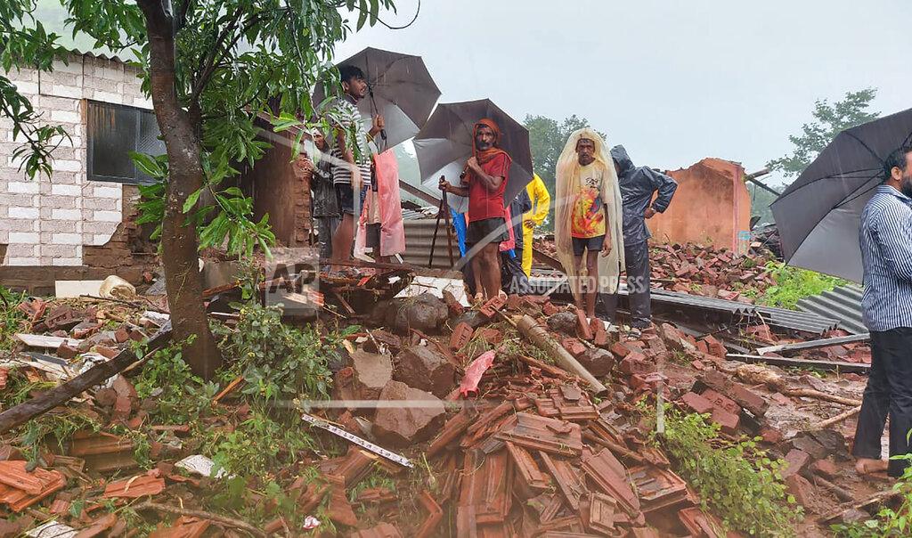 Uncredited People watch rescue efforts after a landslide in Taliye village, in the western Indian state of Maharashtra, Friday, July 23, 2021. Landslides triggered by heavy monsoon rains hit parts of western India, killing at least 32 people and leading to the overnight rescue of more than 1,000 other people trapped by floodwaters, officials said Friday. (AP Photo)